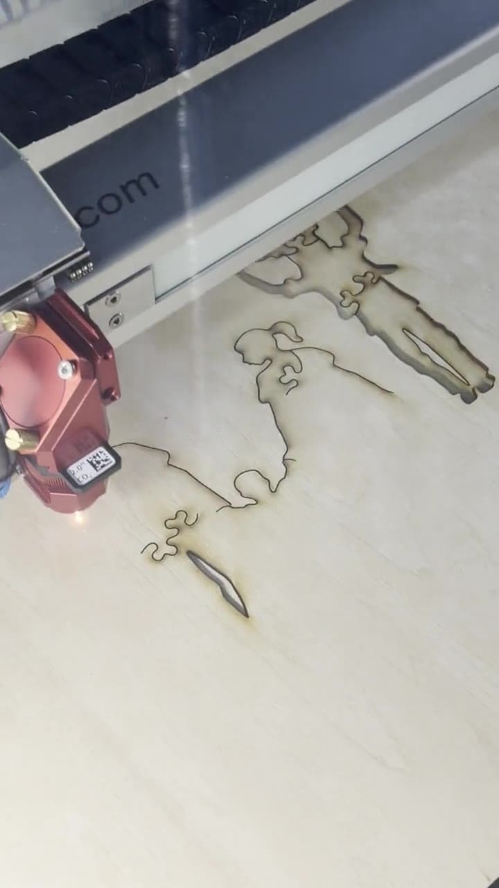 Story-shaped pieces being cut into a Whittled hardwood puzzle